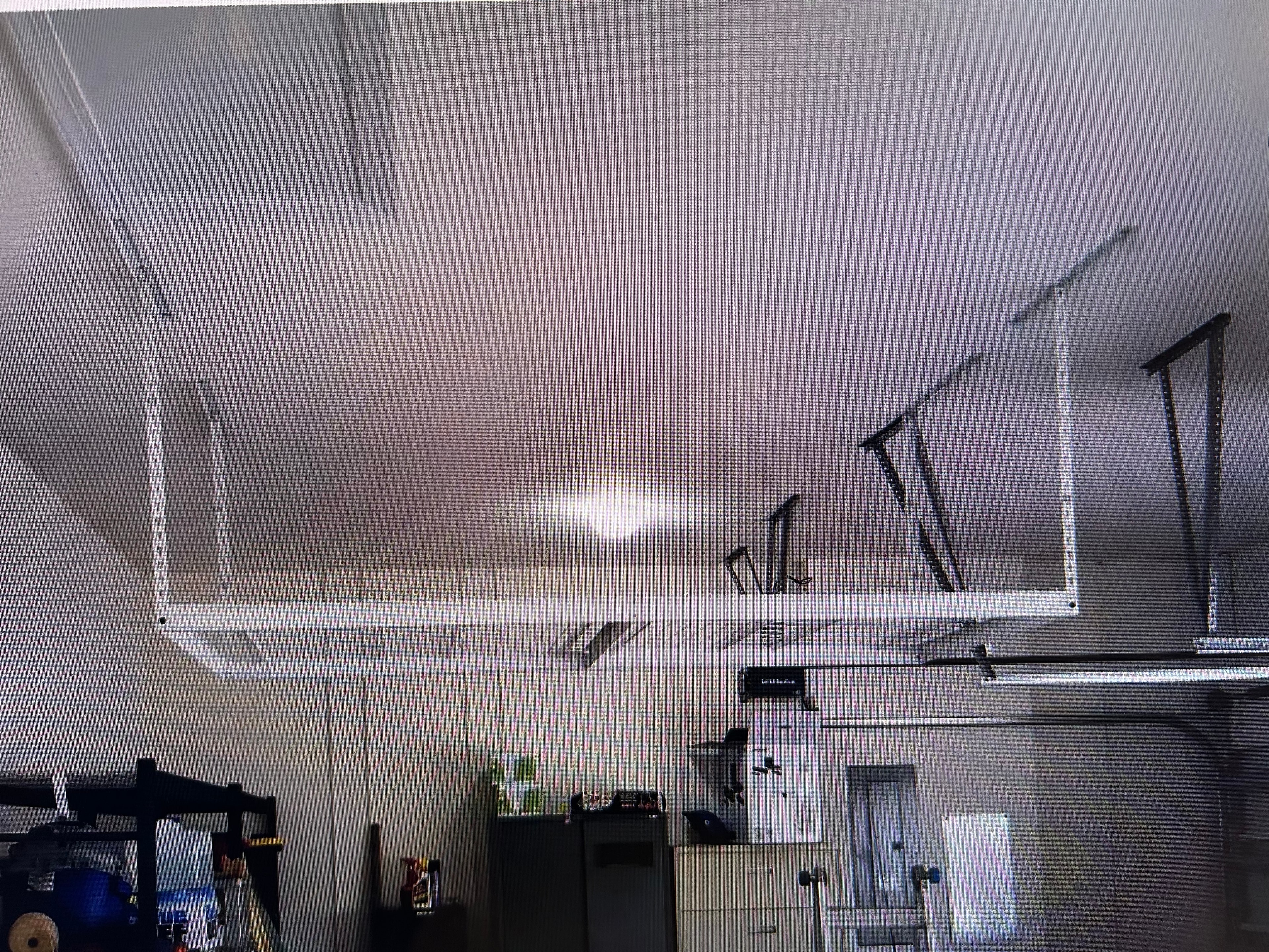 Suspended garage storage shelf